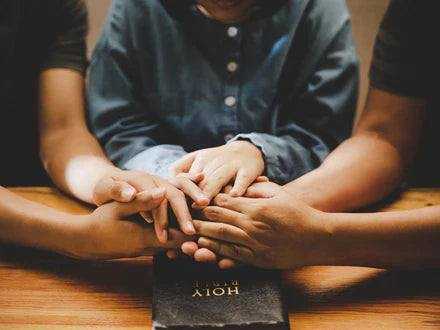 Hands gently holding a small glowing heart symbolizing blessings and gratitude