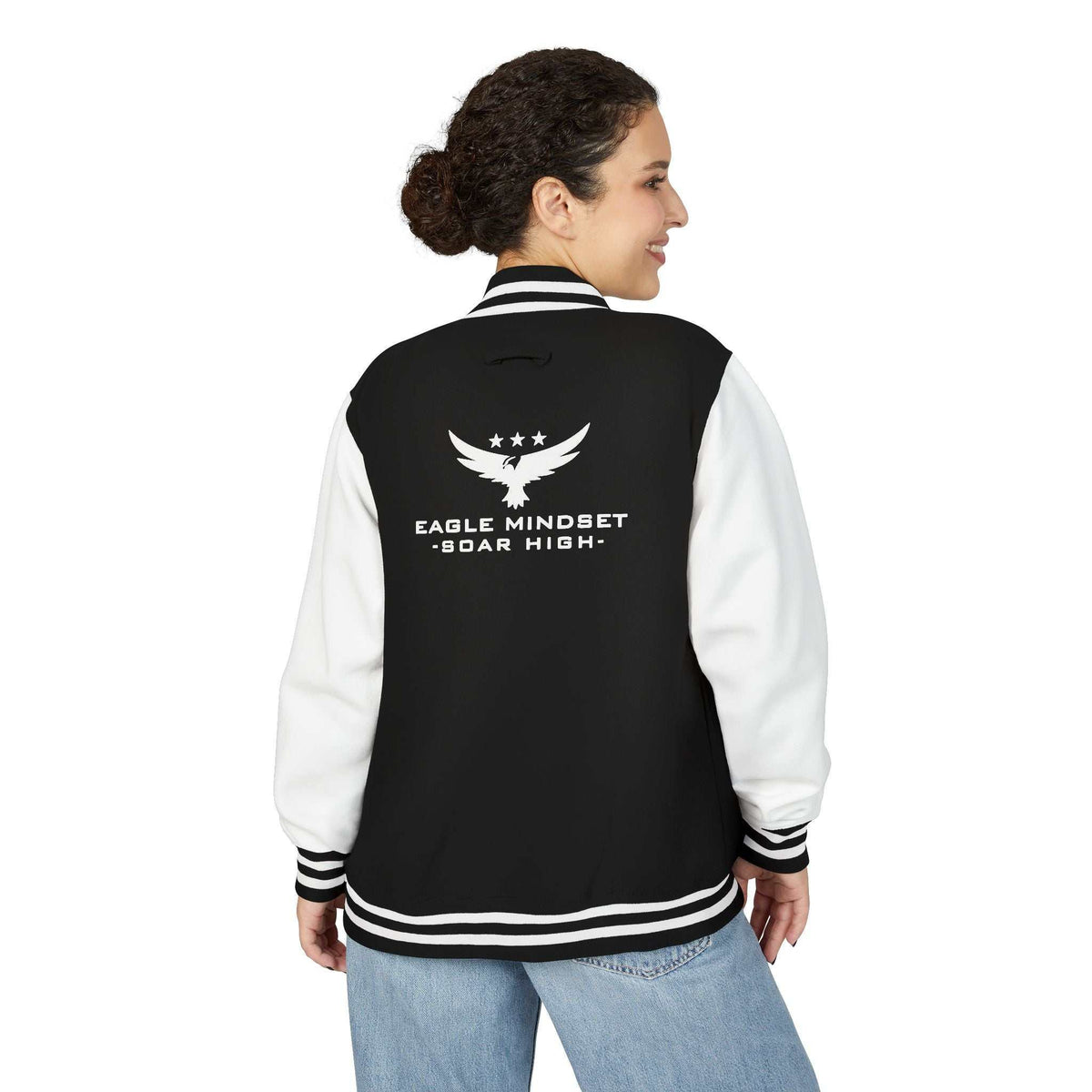 Black and white Eagle Mindset jacket with white sleeves and logo on the back, worn by a woman