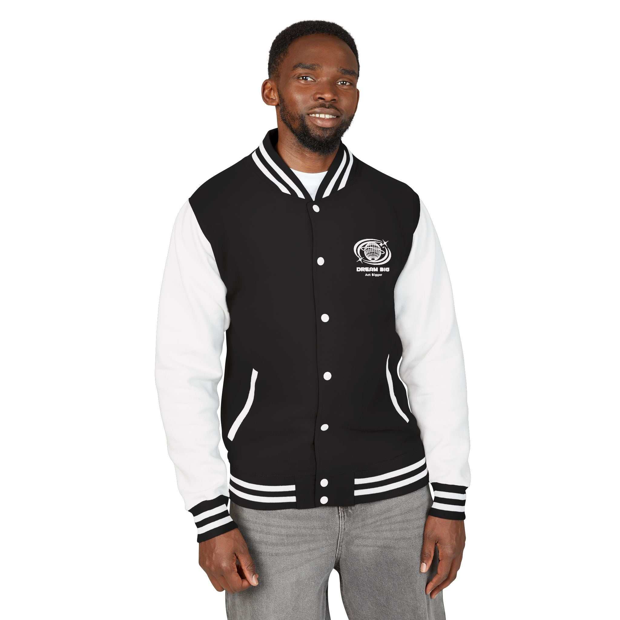 Man wearing Dream Big black and white varsity jacket with logo on chest and striped cuffs