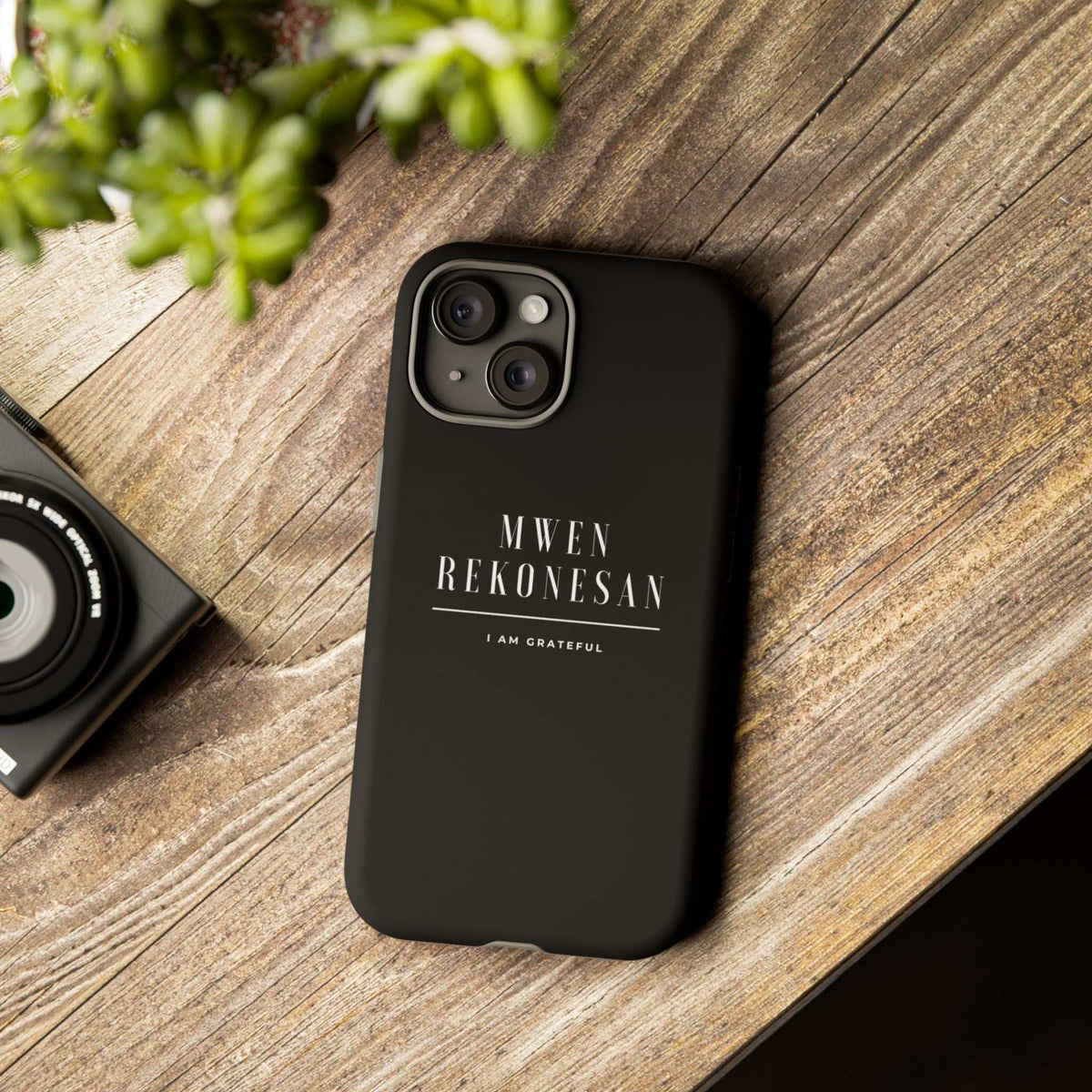 Black Mwen Rekonesan phone case with Haitian Creole gratitude message on wooden surface