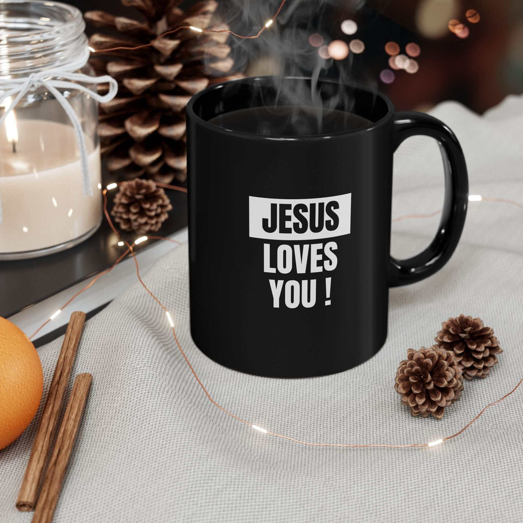 Black ceramic mug with "Jesus Loves You" text, microwave and dishwasher safe, durable coffee cup with C-shaped handle
