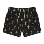 Black swim trunks with watercolor-style green and brown cross patterns