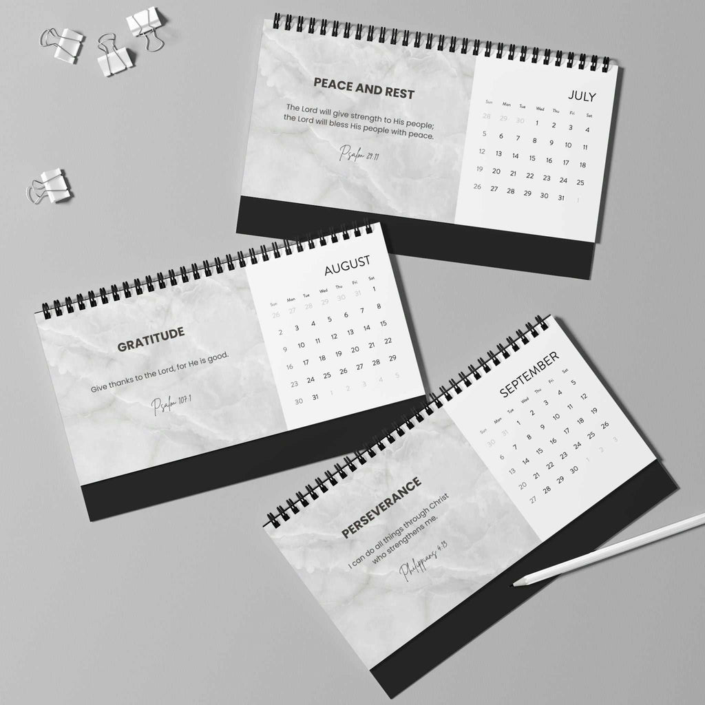 Grace Daily Calendar 2026 with black spiral binding showing monthly grid on matte finish paper