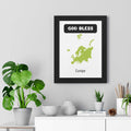 God Bless Europe poster with map of Europe in green on white background in black frame displayed above white shelf with plants and books