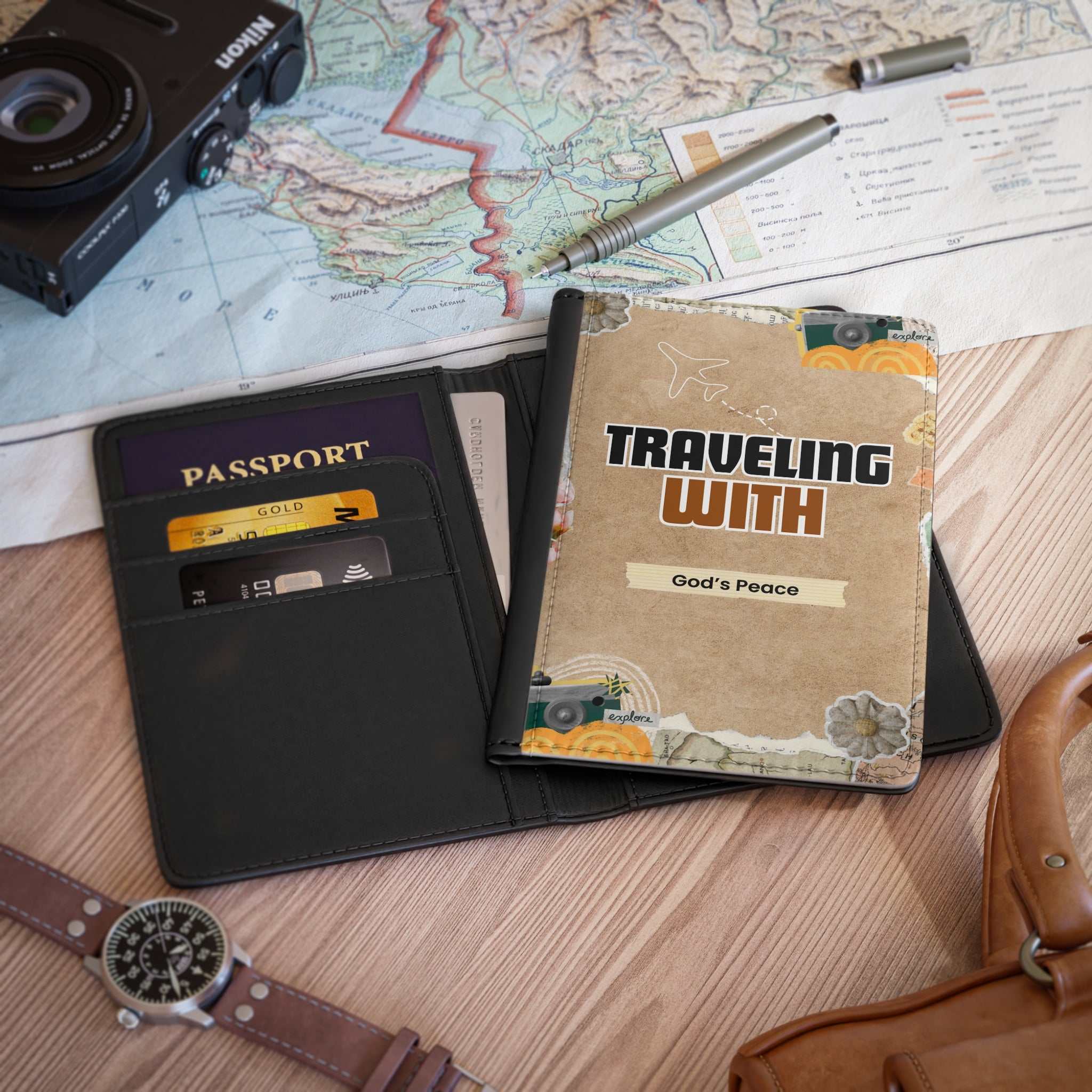 God’s Peace Passport Cover with RFID blocking and card pockets on travel table with camera and watch