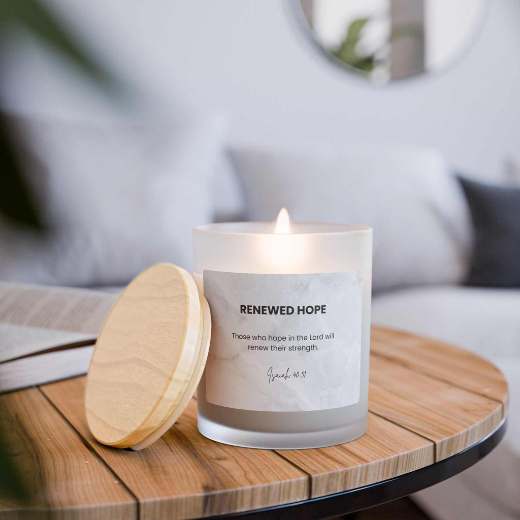 Natural off-white Renewed Hope Candle with wooden wick in frosted glass vessel and raw maple lid