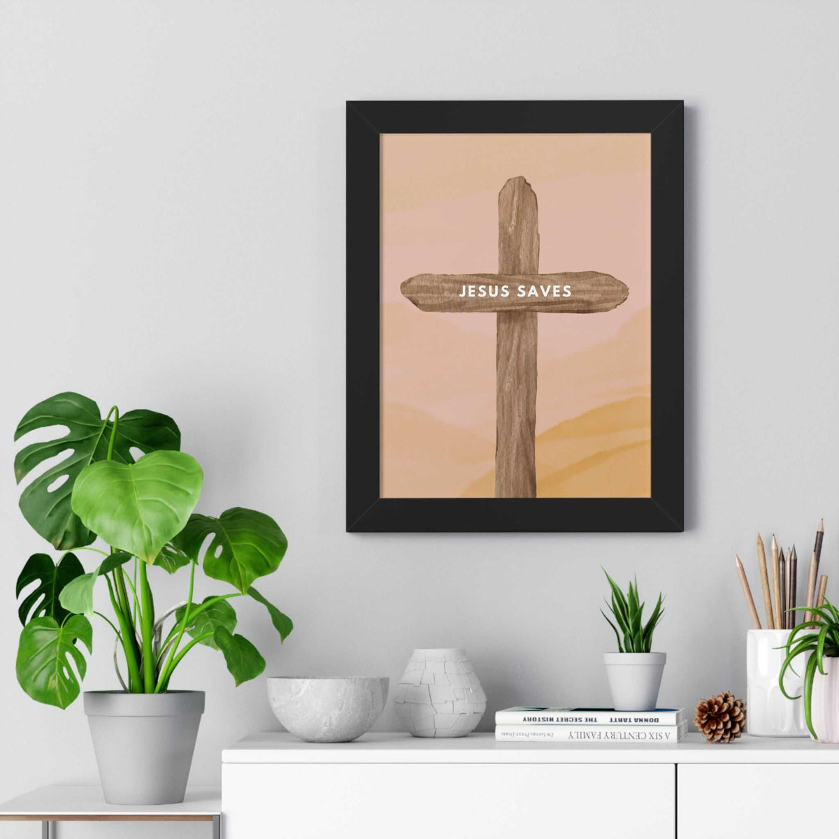 Framed Jesus Saves poster with wooden cross design on wall for faith and inspiration