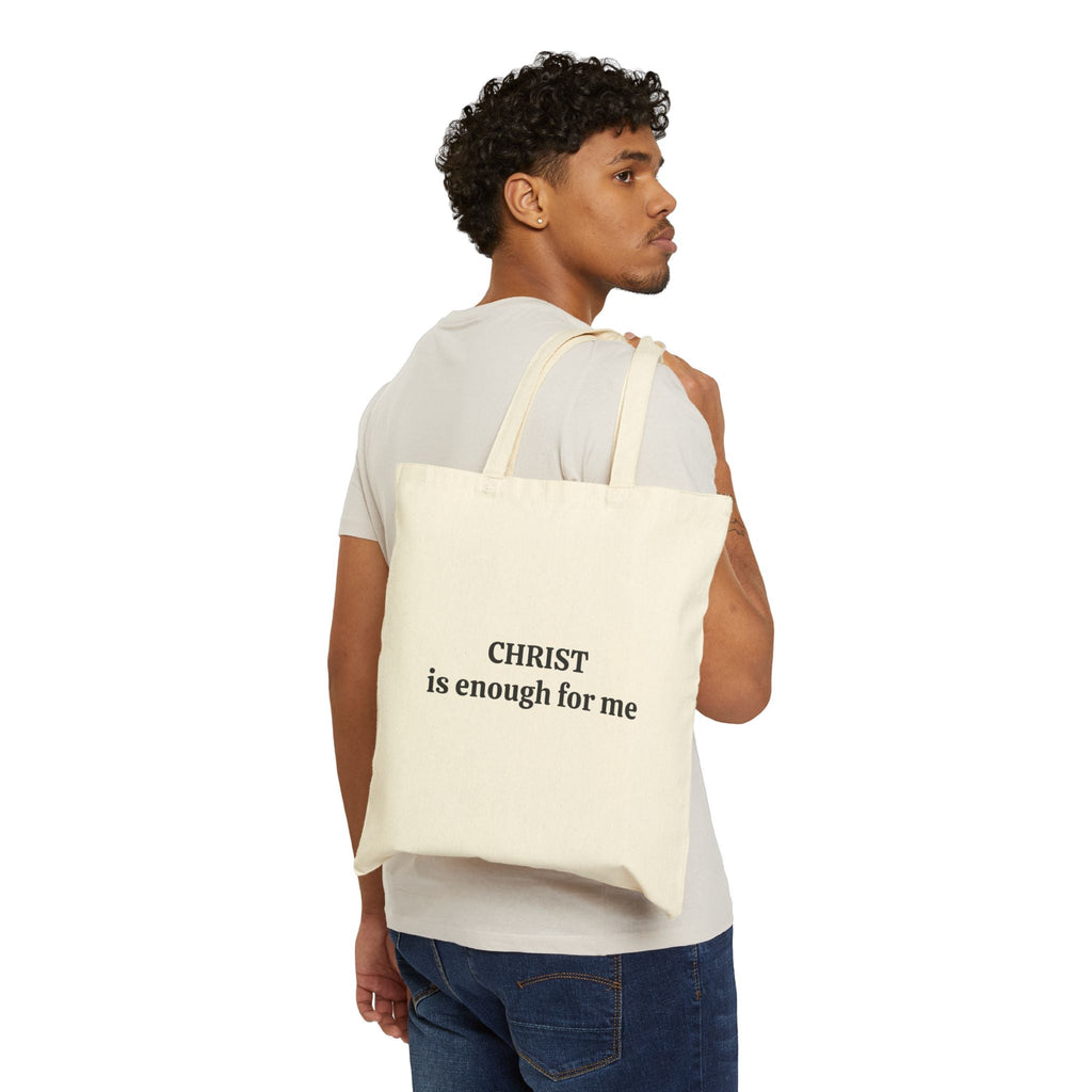 Man carrying Tote Bag with "CHRIST is enough for me" text