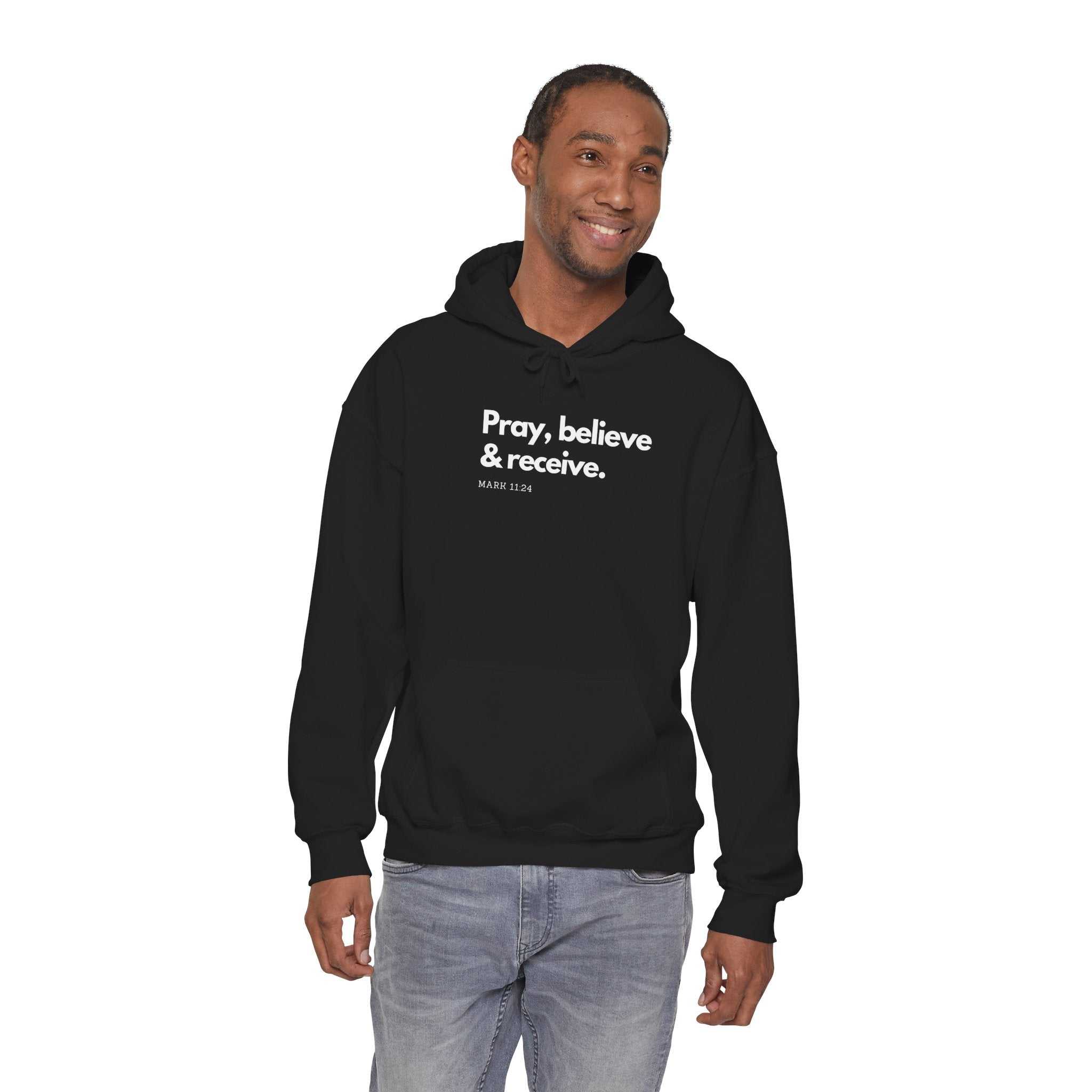 Man wearing black Pray & Receive Hoodie with front kangaroo pocket