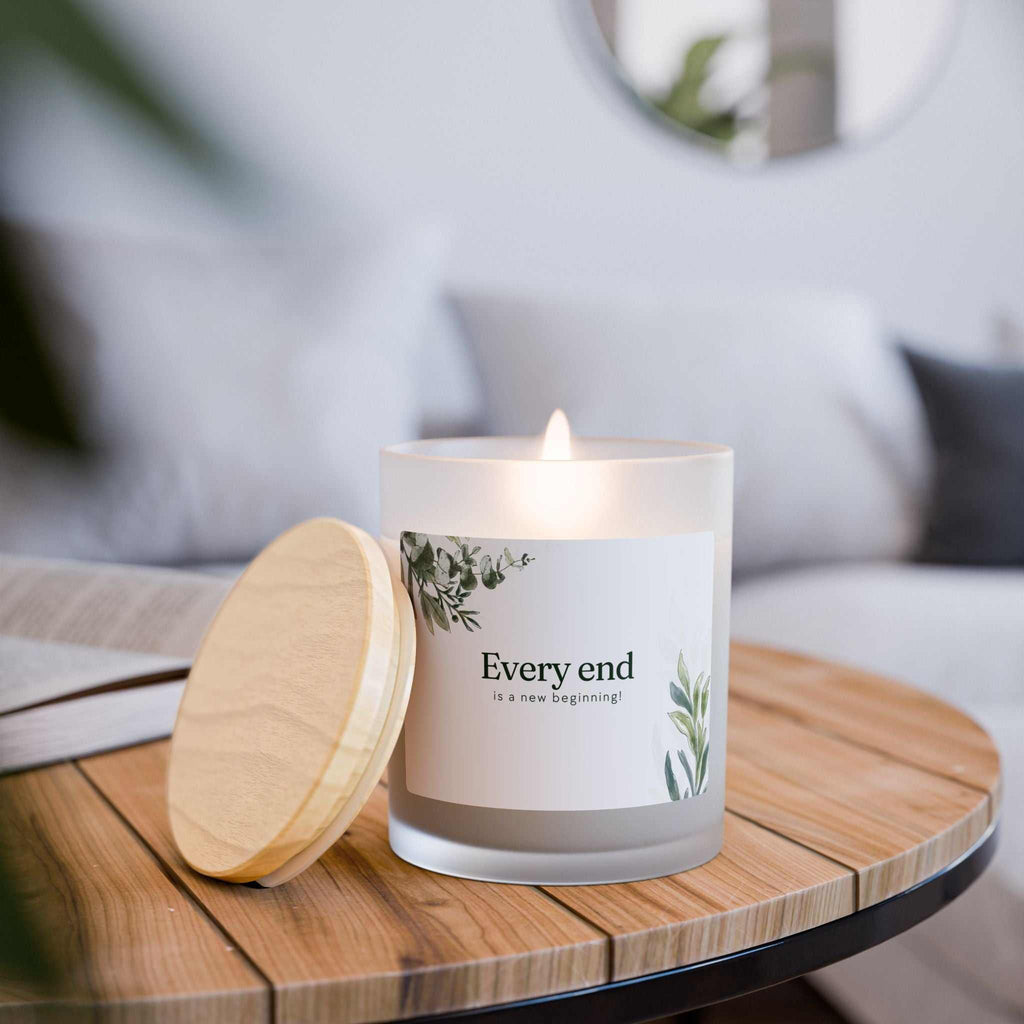 New Beginnings glass candle with coconut soy wax, wooden wick, frosted vessel, and maple lid burning on wooden tray