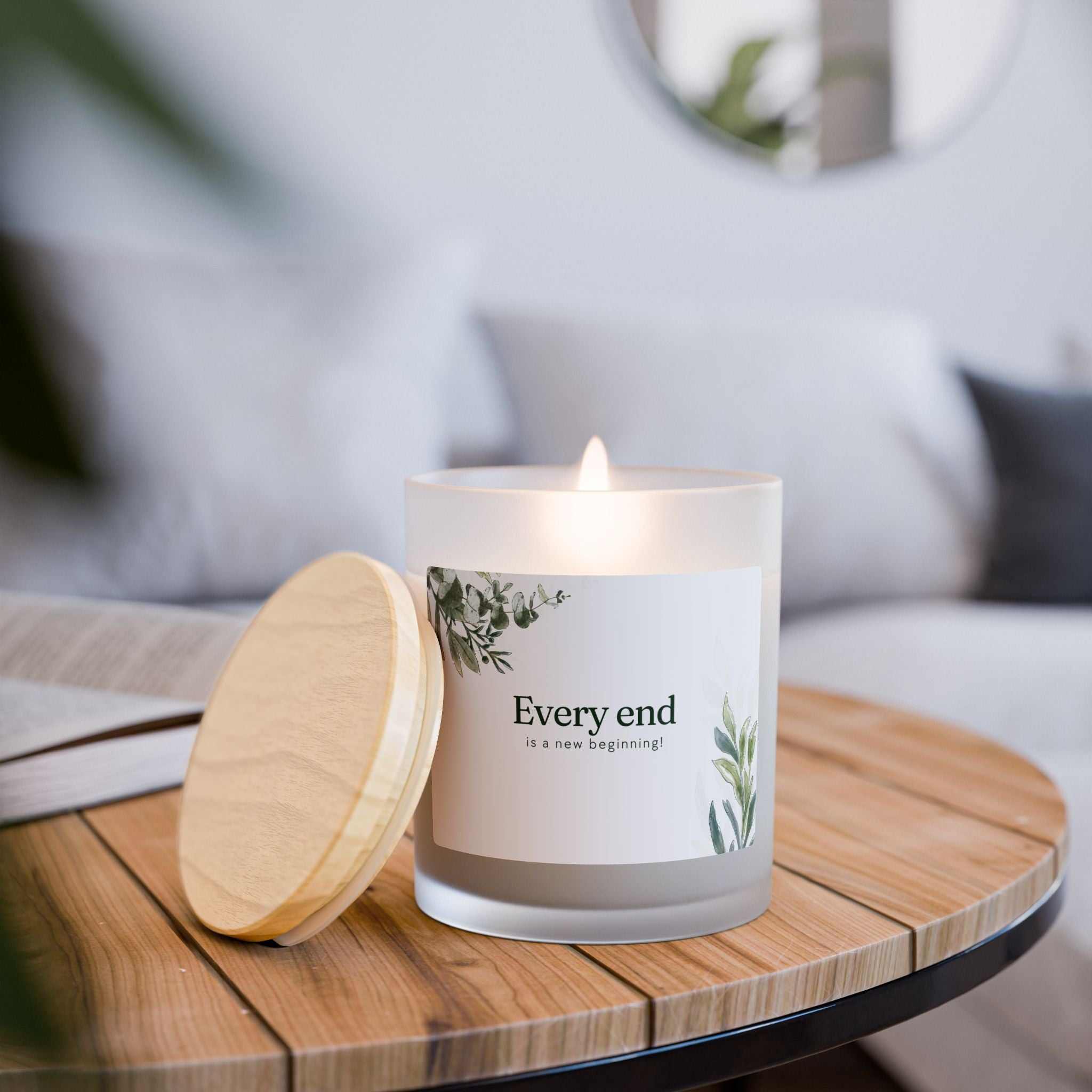 New Beginnings glass candle with coconut soy wax, wooden wick, frosted vessel, and maple lid burning on wooden tray