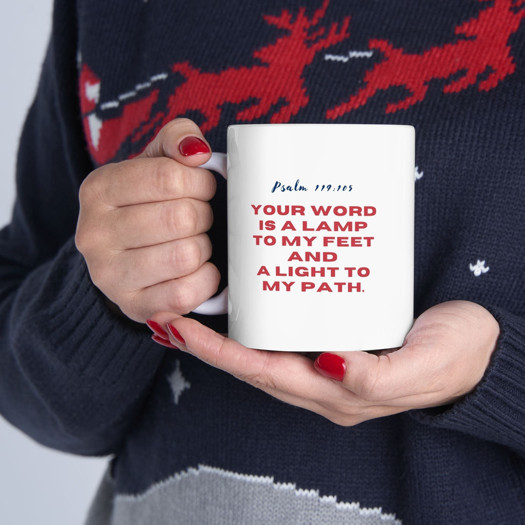 Ceramic Psalm 119:105 mug with inspirational scripture and C-shaped handle held by person in festive sweater