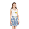 Girl wearing a mid-length sleeveless sundress with a white top featuring "Smile" and a smiley face, and a blue A-line skirt with white daisies.