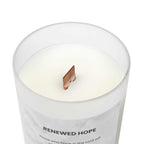 Natural off-white Renewed Hope Candle with wooden wick in frosted glass vessel and raw maple lid