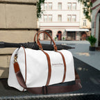 White and brown Jesus is King travel bag with gold zipper and adjustable shoulder strap