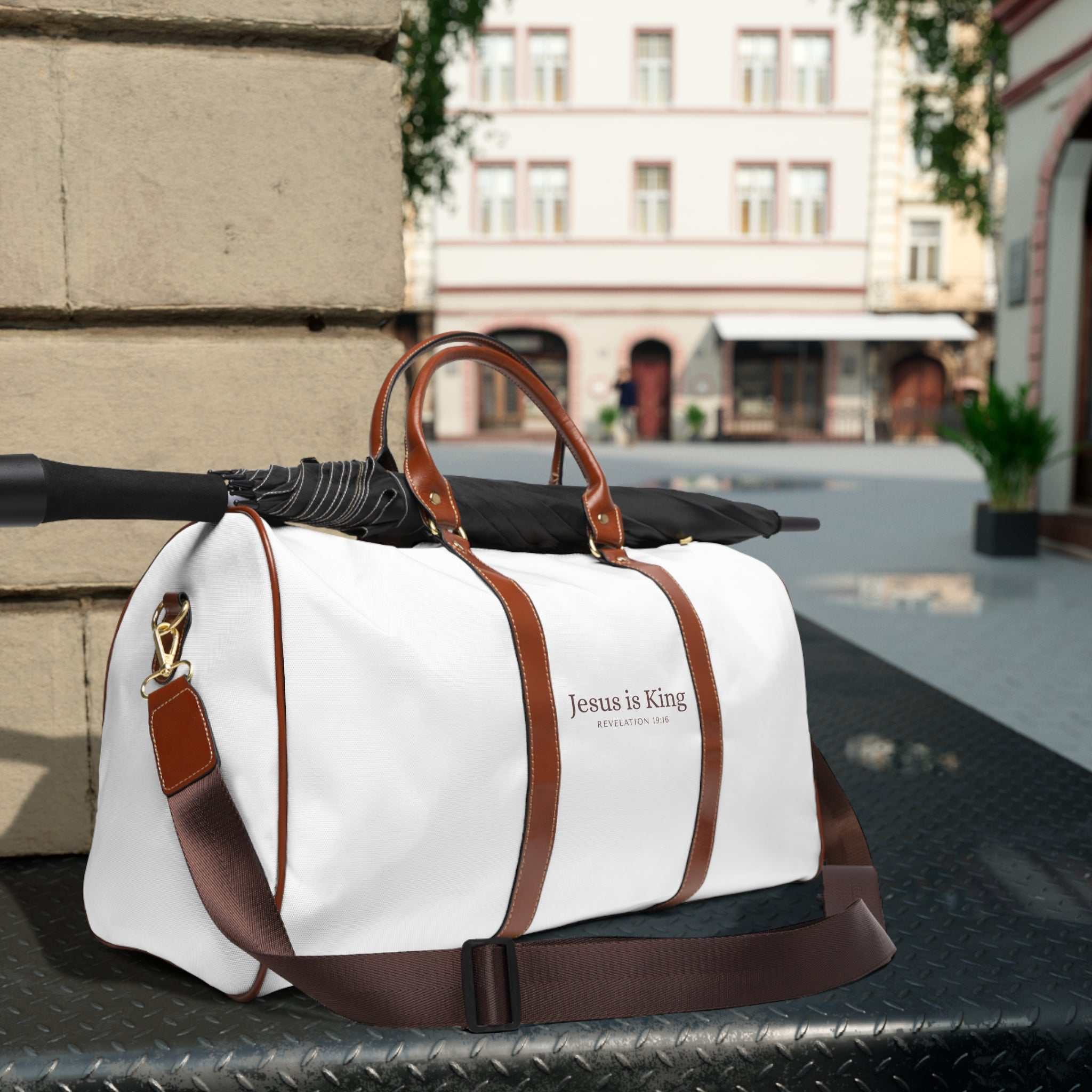 White and brown Jesus is King travel bag with gold zipper and adjustable shoulder strap