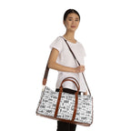 Woman holding a Faith Travel Bag with brown PU leather handles