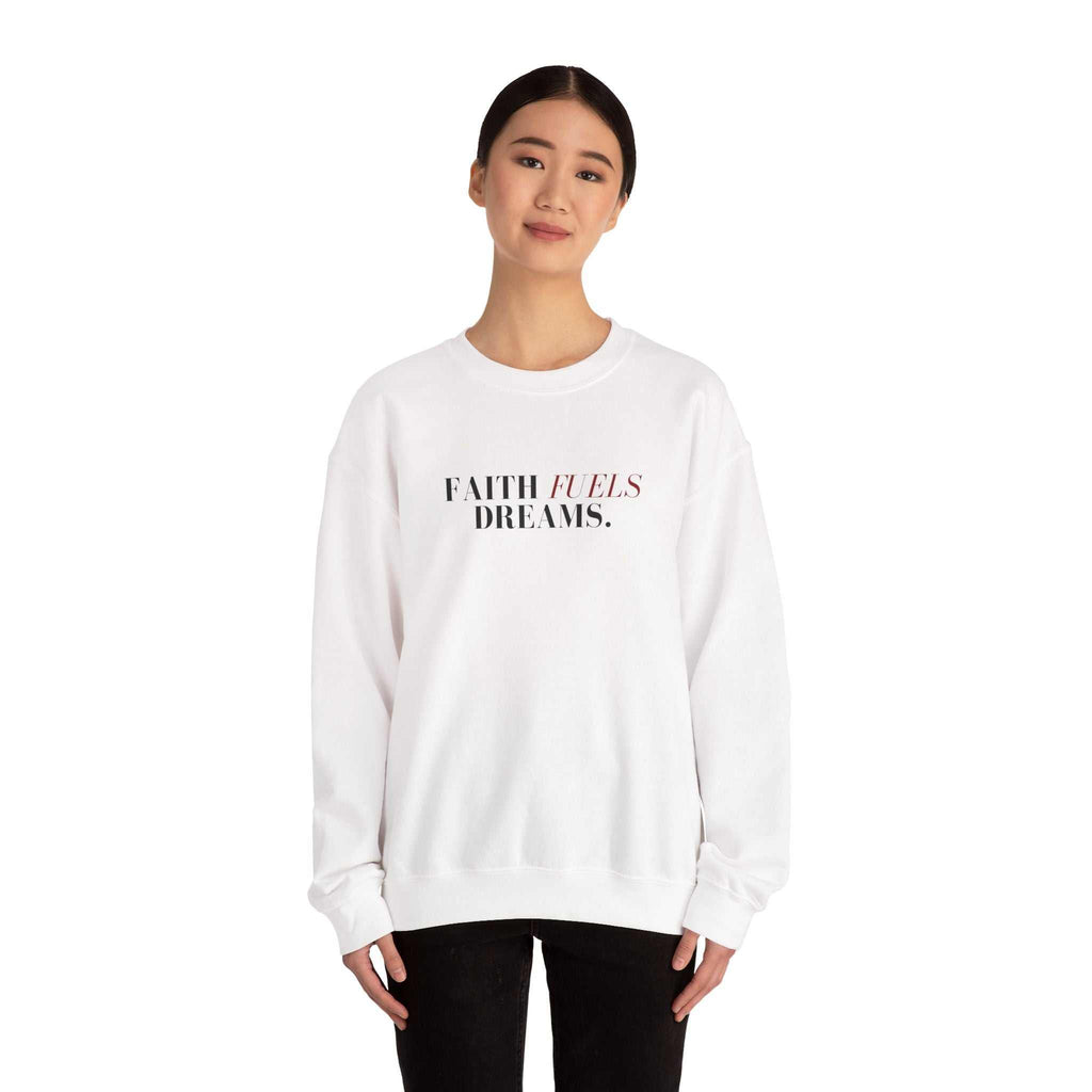 Woman wearing white Faith Fuels Dreams sweatshirt with classic fit and inspirational text