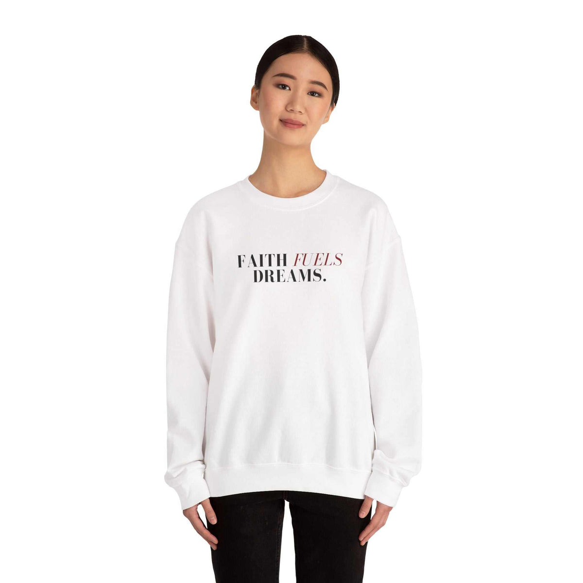 Woman wearing white Faith Fuels Dreams sweatshirt with classic fit and inspirational text