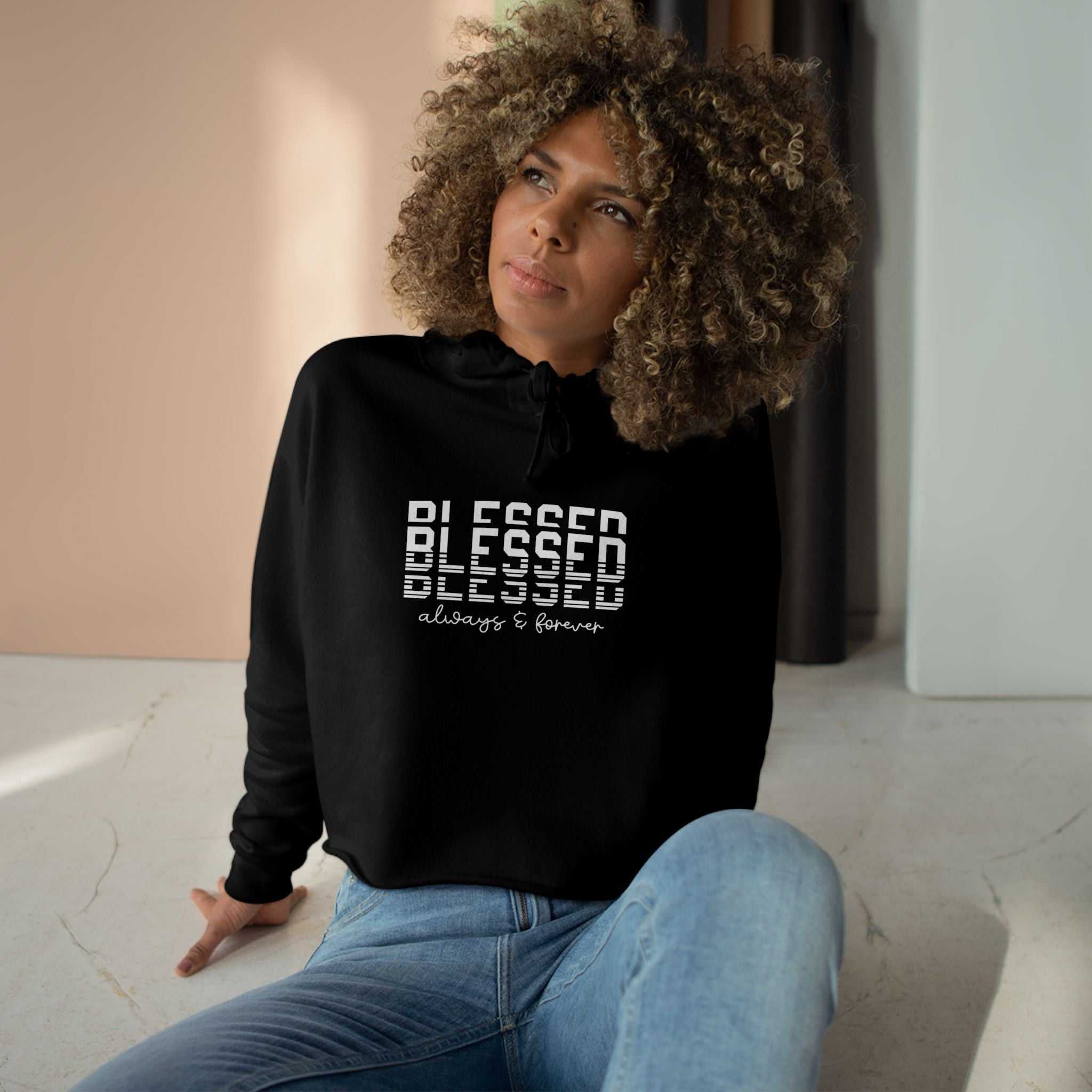 Woman wearing black inspirational crop hoodie with blessed text